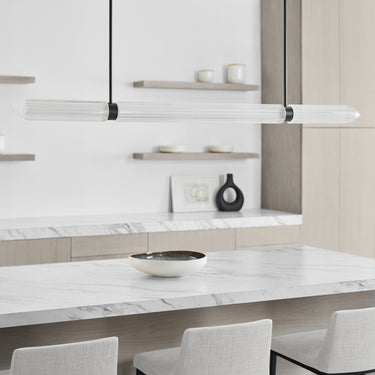 Visual Comfort Langston linear LED chandelier over kitchen island in luxury home interior