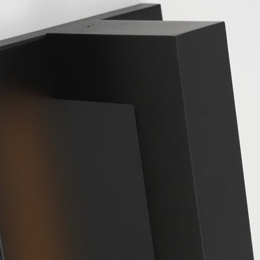 Stagger Small indirect outdoor wall sculpture glowing on a modern facade