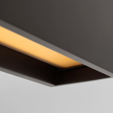 Long dark bronze brass chandelier, dimmable LED, casting glare-free light in a modern living room.