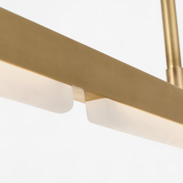 Linea 60 alabaster linear chandelier brings warm light to a styled space