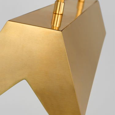 Pench Medium tapered brass linear chandelier setting the mood in a lived-in room