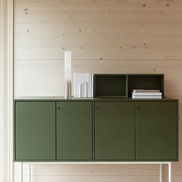 Elise table lamp by Pablo beside a green cabinet