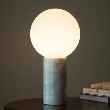 Pilar table lamp by Pablo on a walnut table, landscape photograph
