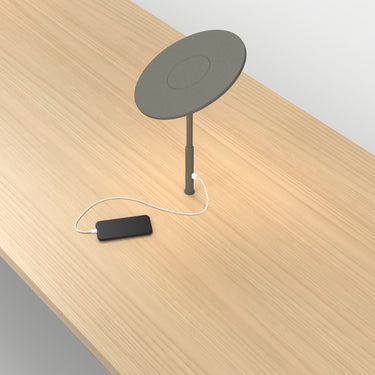 Circa Grommet lamp by Pablo with a phone charging