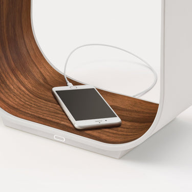 Contour small table lamp by Pablo with a phone