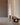 Black Elise floor lamp by Pablo beside a walnut bench