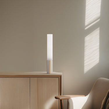 Elise table lamp by Pablo beside an oak cabinet