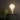 Pilar table lamp by Pablo beside a green sofa