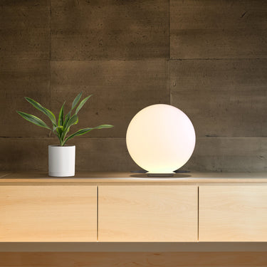 16 inch Bola Sphere table lamp by Pablo on an oak cabinet