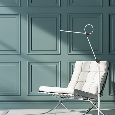 Superlight floor lamp by Pablo against a teal wall
