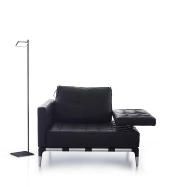 Talia floor lamp by Pablo next to an armchair