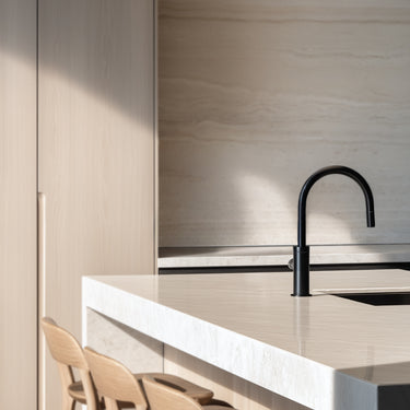 Totem Mini up/down pendant in etched smoke by Pablo in an oak kitchen
