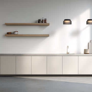 Totem Mini pendants in etched smoke by Pablo over a kitchen sink
