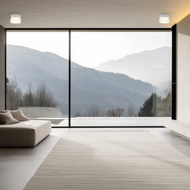 Totem Mini flush mount trio by Pablo in a room with a large window
