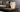 Totem Table lamp by Pablo beside a corner sofa
