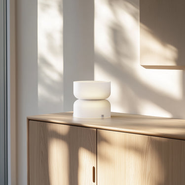 Totem Table Mini white lamp by Pablo on an oak cabinet