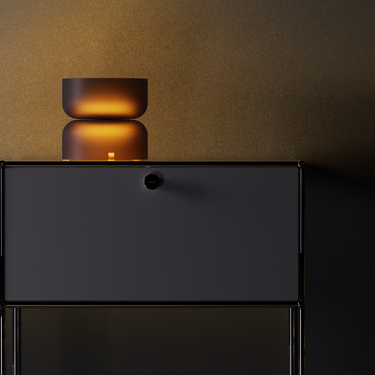 Totem Table Mini amber lamp by Pablo in a dark room