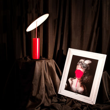 Table lamp, beside a framed portrait | Parasol by Innermost