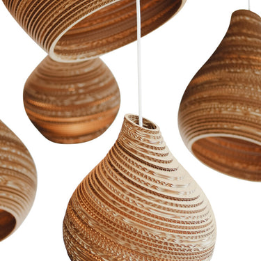 Close detail of angled cardboard layers on a grouping of Natural Hive pendants