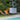 Smart & Green Dice cube lamp beside a pool with orange lounge chairs