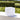 Smart & Green Dice white cube lamp on a stone ledge beside the water