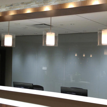 Pahu stem pendants over a front desk | Besa Lighting