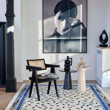 Trasimène wool rug in White, styled in a room