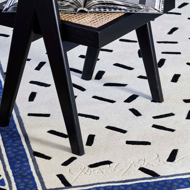 Trasimène wool rug in White, styled in a room