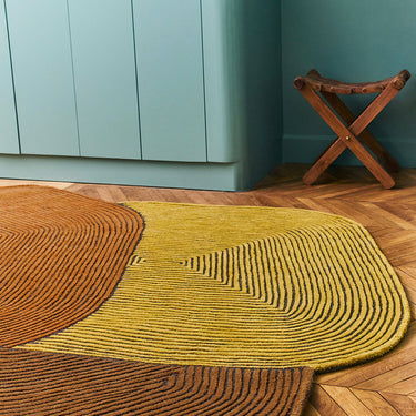 Tumulus wool rug in Saffron, styled in a room