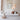 White Hive and Nest cluster of three lit cardboard pendants hanging above a white sofa in a bright living room