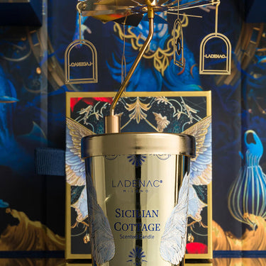 Ladenac Sicilian Cottage 75 g candle with carousel – candle styled against a deep blue backdrop