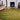 Volute Round wool rug in Green, styled in a room