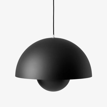 &Tradition Flowerpot VP2 pendant providing downward light over a kitchen island, matte black
