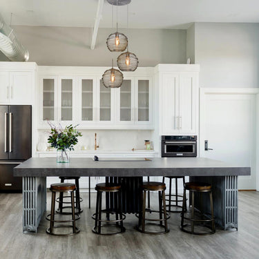 Wave 10 pendants over a kitchen island, Smoke glass | Besa Lighting