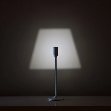Yoy Table Lamp by Innermost on a minimalist study desk, providing clever functional lighting with a decorative projected shade.