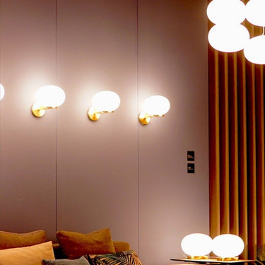 Alba 176 Wall Light by Oluce in satin brass with polished blown glass for modern bedrooms