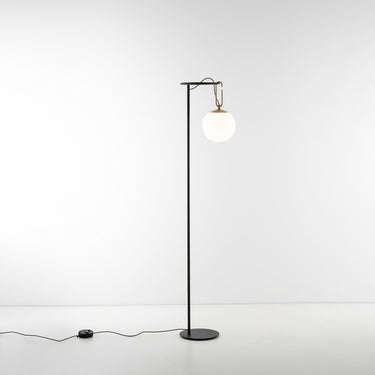 Elegant dimmable Artemide floor lamp with blown glass diffuser and brass accent ring for bedroom reading corner