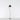 Modern LED floor lamp - Artemide La Petite - casting soft, ambient light in a bedroom, Black finish