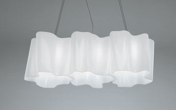 Artemide Logico Triple Linear Suspension in a modern living room.