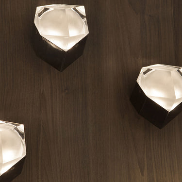 Oluce Astro G9 wall lamp with cast aluminum base and transparent glass