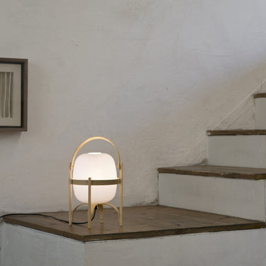 Santa and Cole Cestita lamp on modern bedside table with soft warm glow