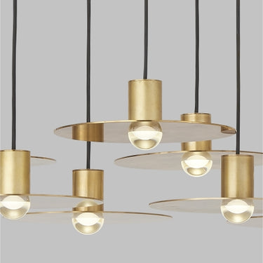 Eaves 18 light linear pendant, natural brass, close-up of domed LED optic, modern linear lighting detail.
