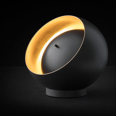 Black and gold Eva modern table lamp by Oluce with indirect reflected LED illumination for luxury interiors