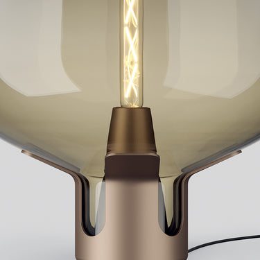 Front view of Lodes Flar table lamp featuring a unique turquoise bubble glass shade.