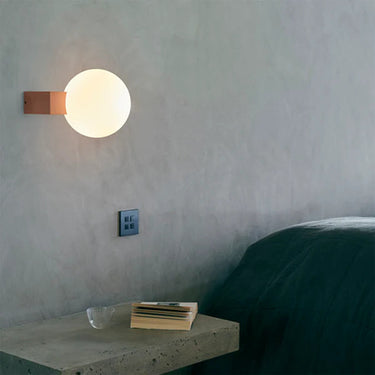 Close-up view of the &Tradition Journey SHY2 mouth-blown opal glass sphere providing soft ambient light. 