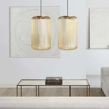 Kai 1 plated brass modern pendant light serves as a focal point in a contemporary living room.
