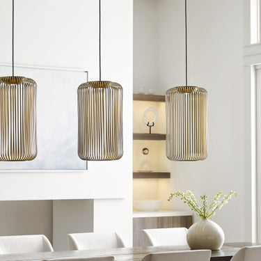 Sleek Kai 1 LED pendant light provides task lighting in a minimalist home office setup.