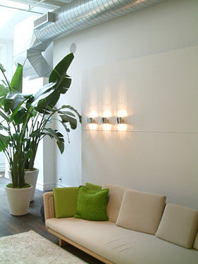 Minimalist Line Wall Lamp by Oluce providing indirect LED lighting for modern living spaces