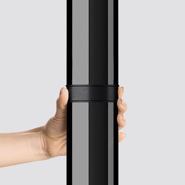 Black ombre Croma floor lamp providing soft, indirect lighting in a contemporary office.