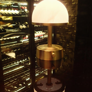 Mini Art Deco Cordless Lamp Antique Brass illuminating a room